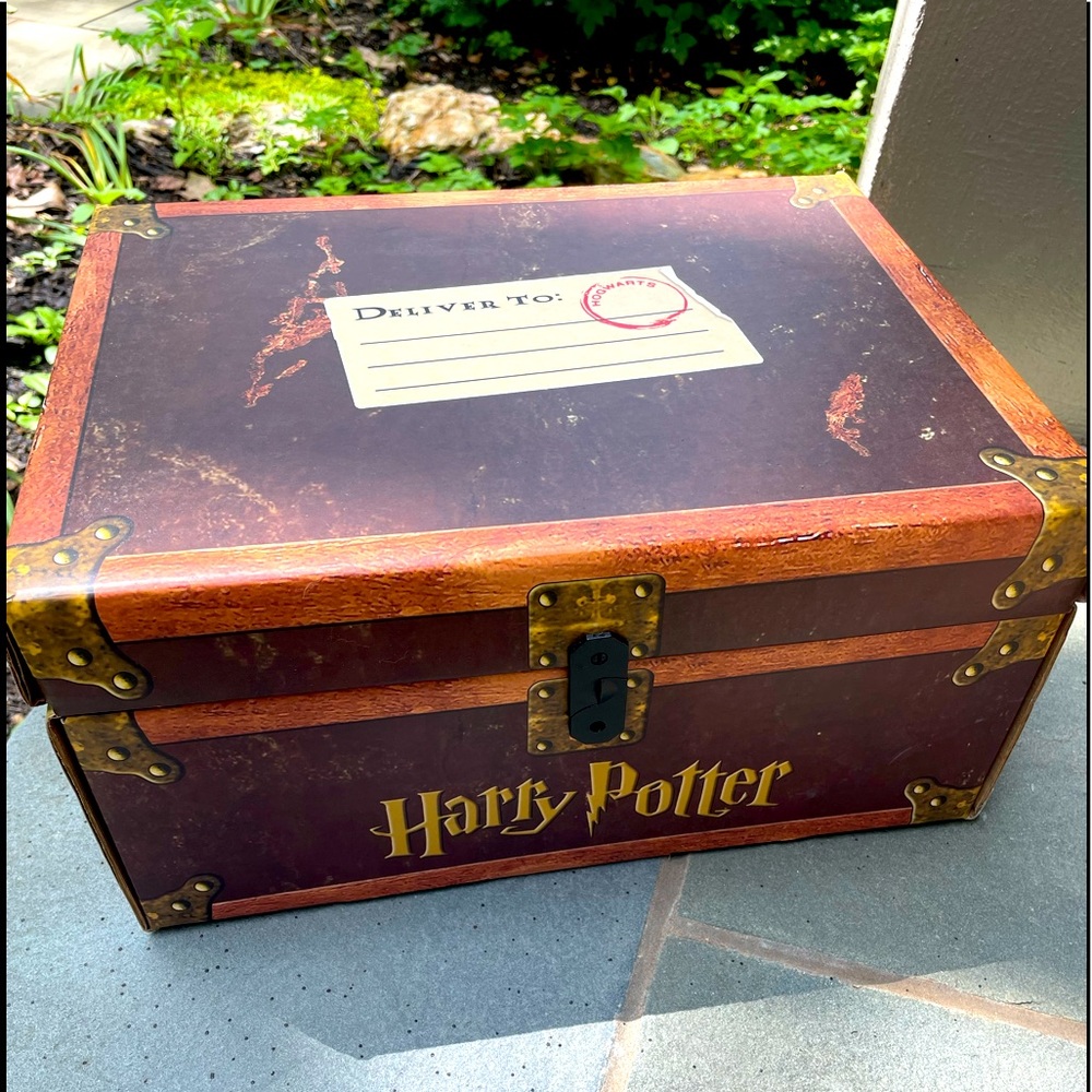 7 Year collection of hardcover Harry Potter novels in a decorative trunk.